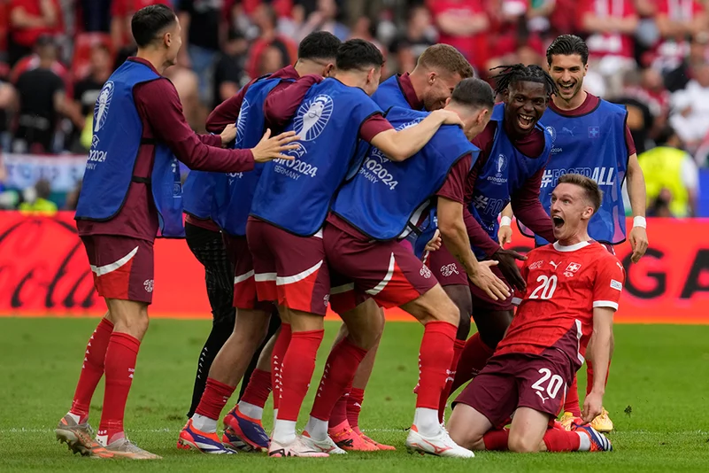 Switzerlands players celebrate scoring their sides second goal 